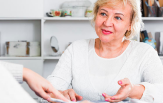 A woman smiling and talking to someone, explaining the answer to the question, What is Trust Accounting for a Trust?