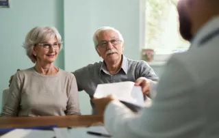 Elderly couple reviewing trust documents to protect assets from nursing home costs