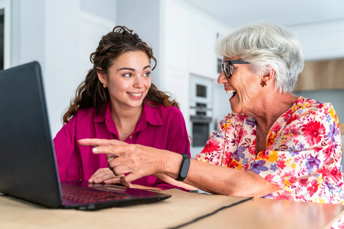 Senior woman and adult daughter reviewing trust documents on the table