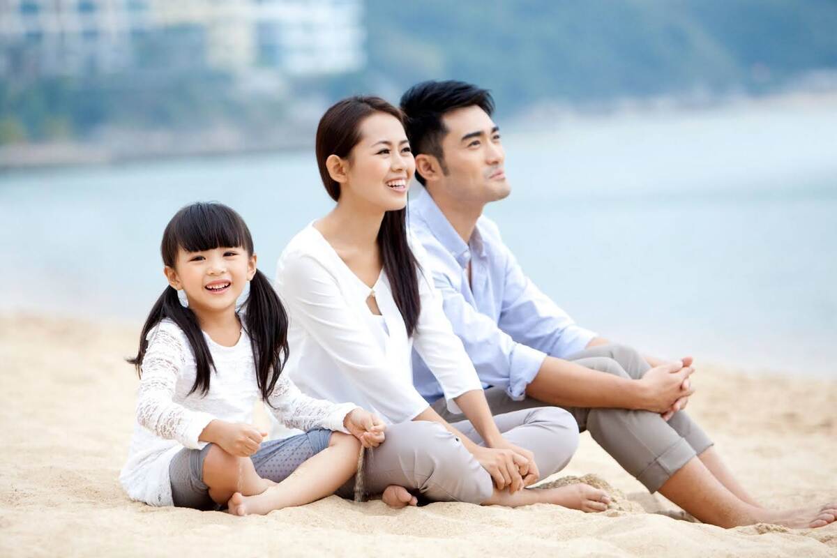 what happens to a trust when a trustee dies A happy family sitting on a beach with peace of mind after finding out what happens to a trust when the trustee dies and how a professional can help ease that process.