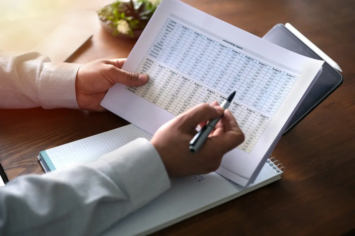 Small business owner working with a CPA on financial statements.