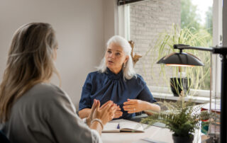 A trustee working with a CPA to perform a trust accounting, both business attire and explaining