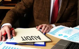 what makes a good auditor: a professional auditor writing a comprehensive audit report for a nonprofit organization's financial review