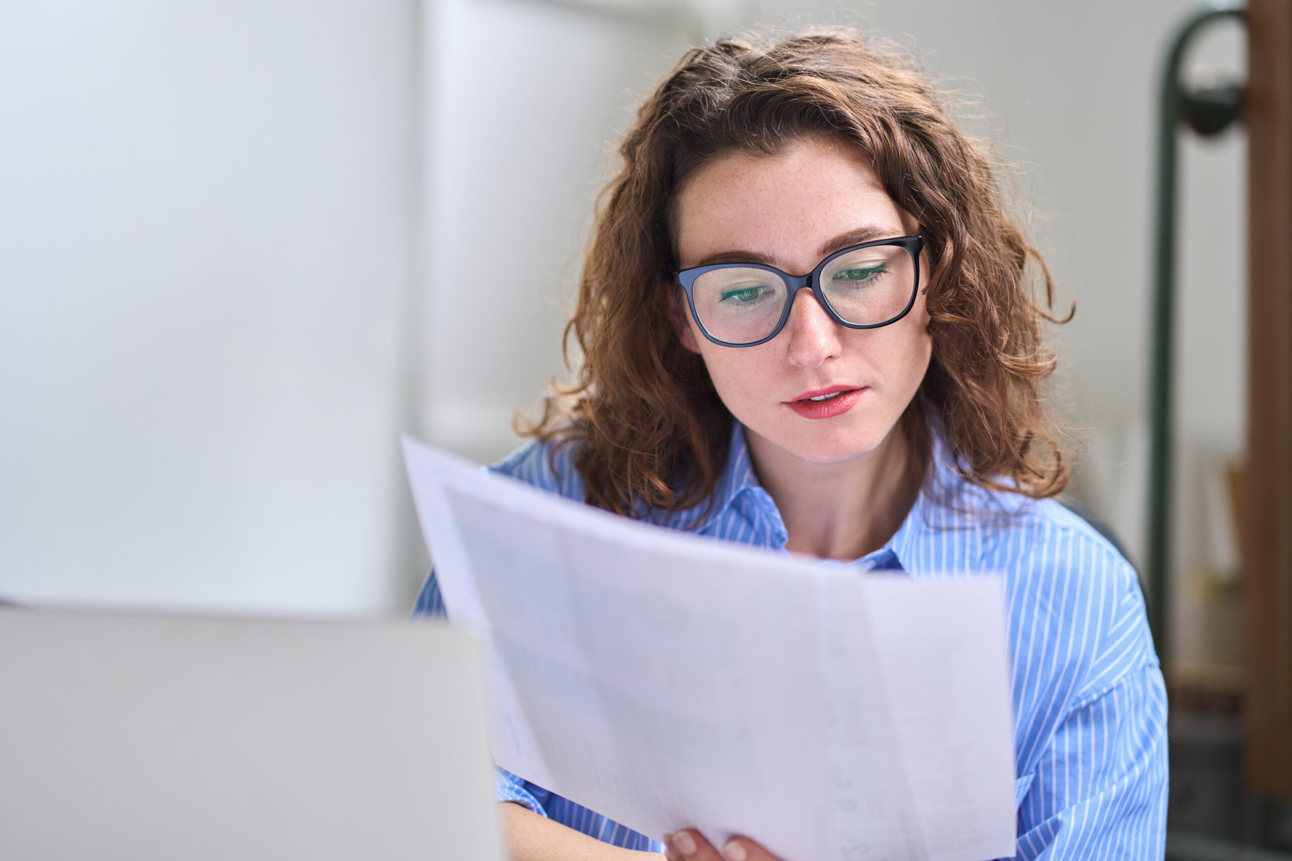 A specialist CPA in glasses with long curly hair preparing an accurate and compliant California trust accounting for a trustee