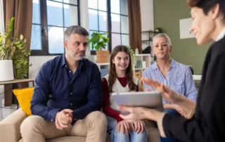 Young family meeting with advisor, discussing what fiduciaries are not allowed to do? in detail