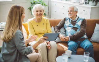 Advisor shows tablet to older couple during talk on 3 steps before hiring a professional fiduciary