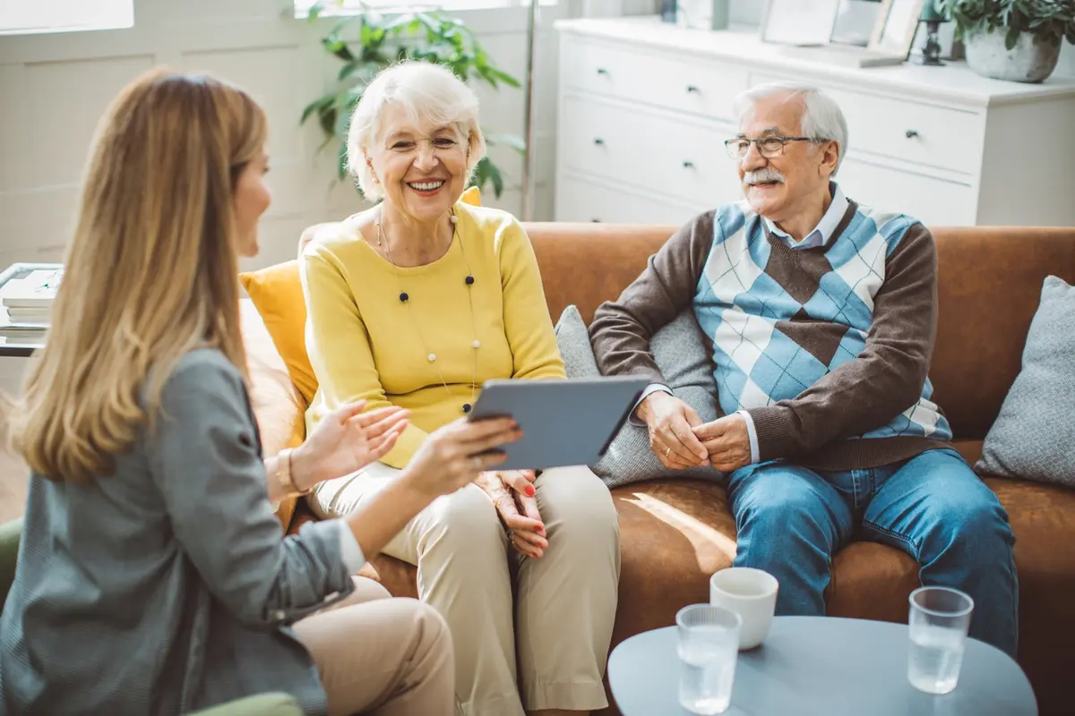 Advisor shows tablet to older couple during talk on 3 steps before hiring a professional fiduciary