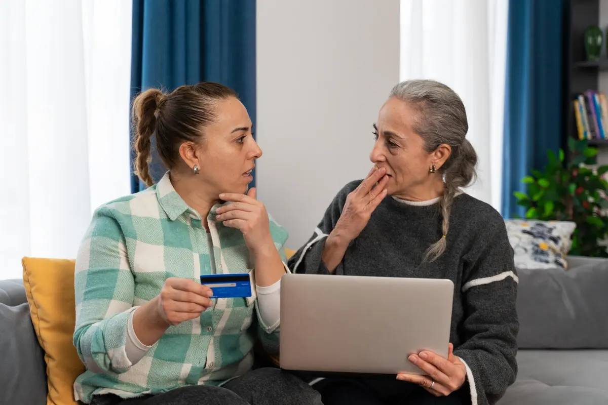 5 Scams That Steal From Elderly Seniors: daughter helps mother spot suspicious card charges together