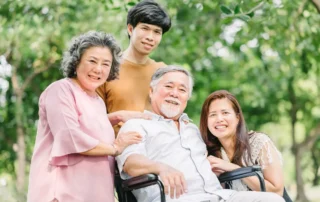 Multigenerational family smiles outdoors, illustrating beneficiaries and family support