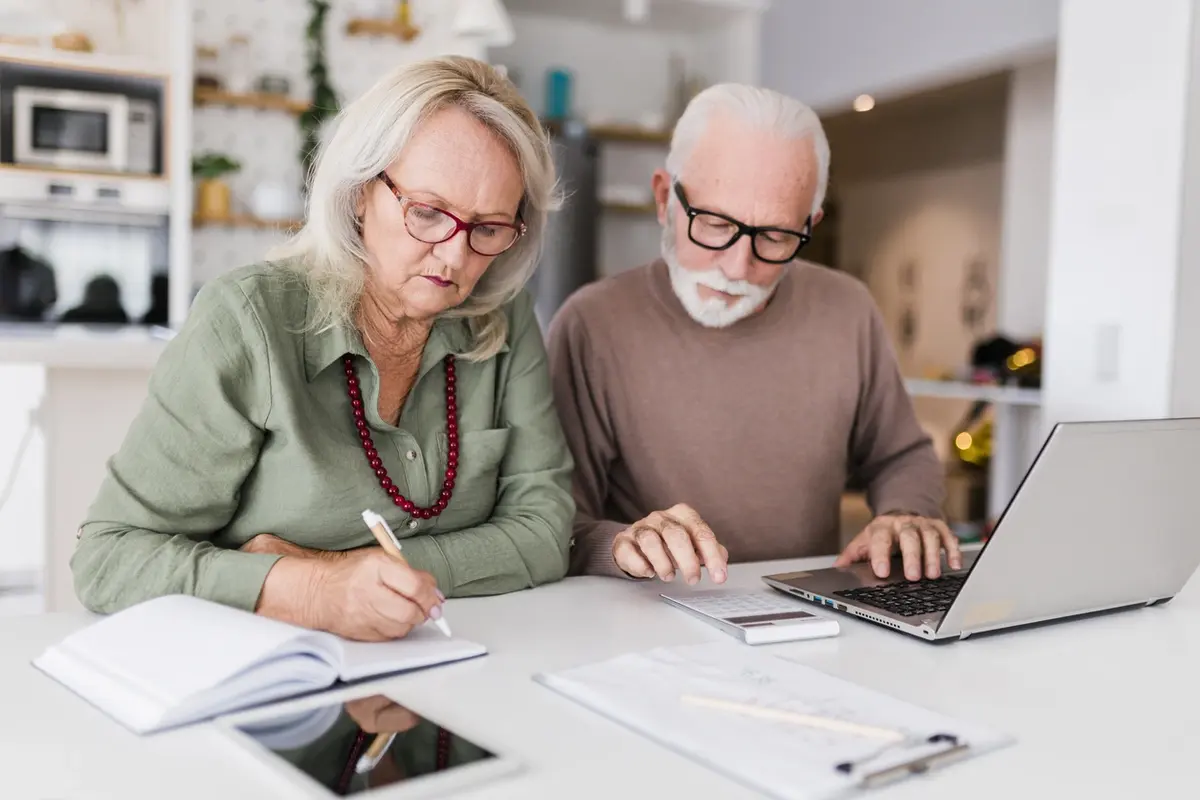 A senior who is calculating his tax deductions after reviewing the key advantages to capitalize on for elderly individuals filing their tax returns.