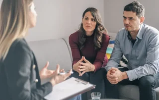 Advisor speaks with concerned couple about Depressed Valuations in a private financial meeting
