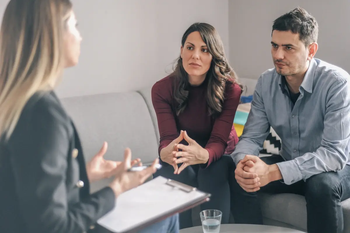 Advisor speaks with concerned couple about Depressed Valuations in a private financial meeting