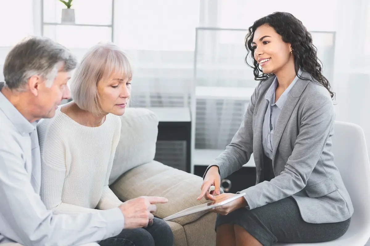 Advisor explains Distribution vs. Disbursement to senior couple during home estate planning meeting