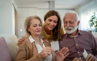 A hand over another offering some support, which is a fitting metaphor for the answer to the question, How do you talk to an aging parent about finances?