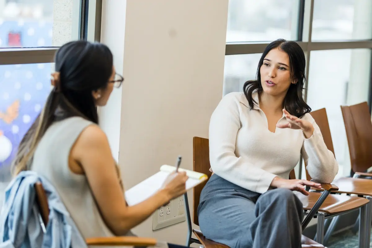 How to Prepare for Taking Over Elderly Parents Finances Someone having a conversation with someone about taking over erderly parents finances.