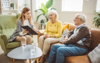Advisor meets older couple at home, explaining reasons for a private fiduciary in California
