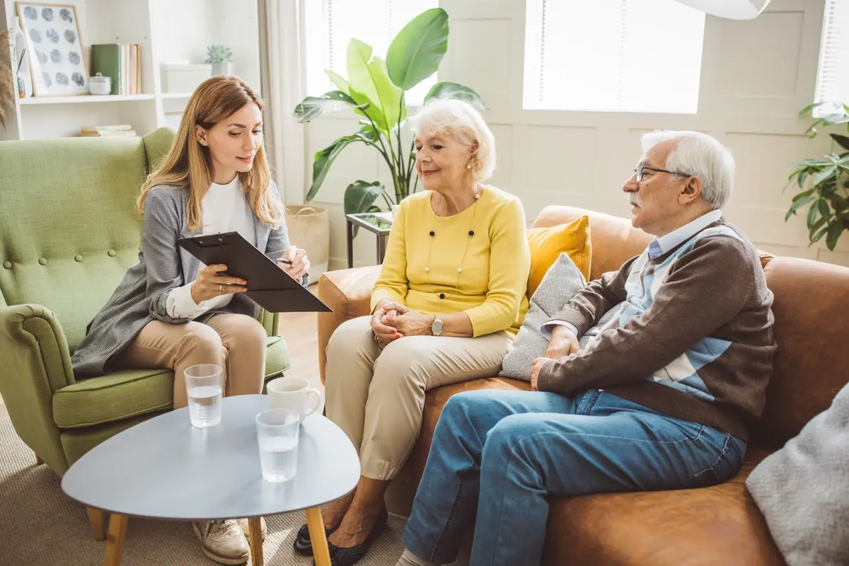 Advisor meets older couple at home, explaining reasons for a private fiduciary in California