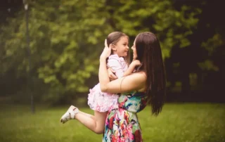 Mother hugs young daughter outdoors, illustrating Special Needs Trusts: Consider These Things