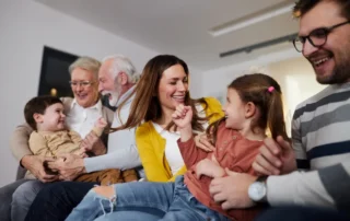 Three generations of family smile together while discussing power of attorney and conservatorship