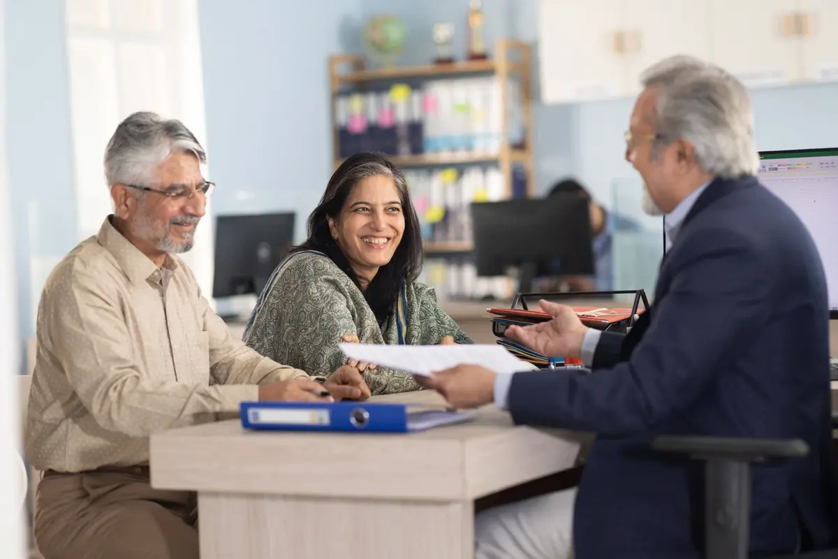 Advisor reviews documents with older couple on what a trustee should include in trust accounting