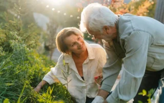 Older man helps woman garden outdoors, illustrating a California Special Needs Trust