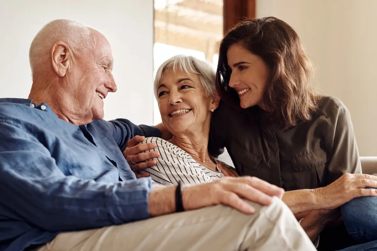 Adult daughter with aging parents, illustrating Parents' Responsibilities in a warm home setting