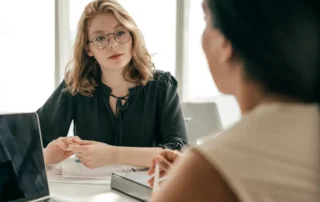 Woman discusses executor options with a client during a private office consultation