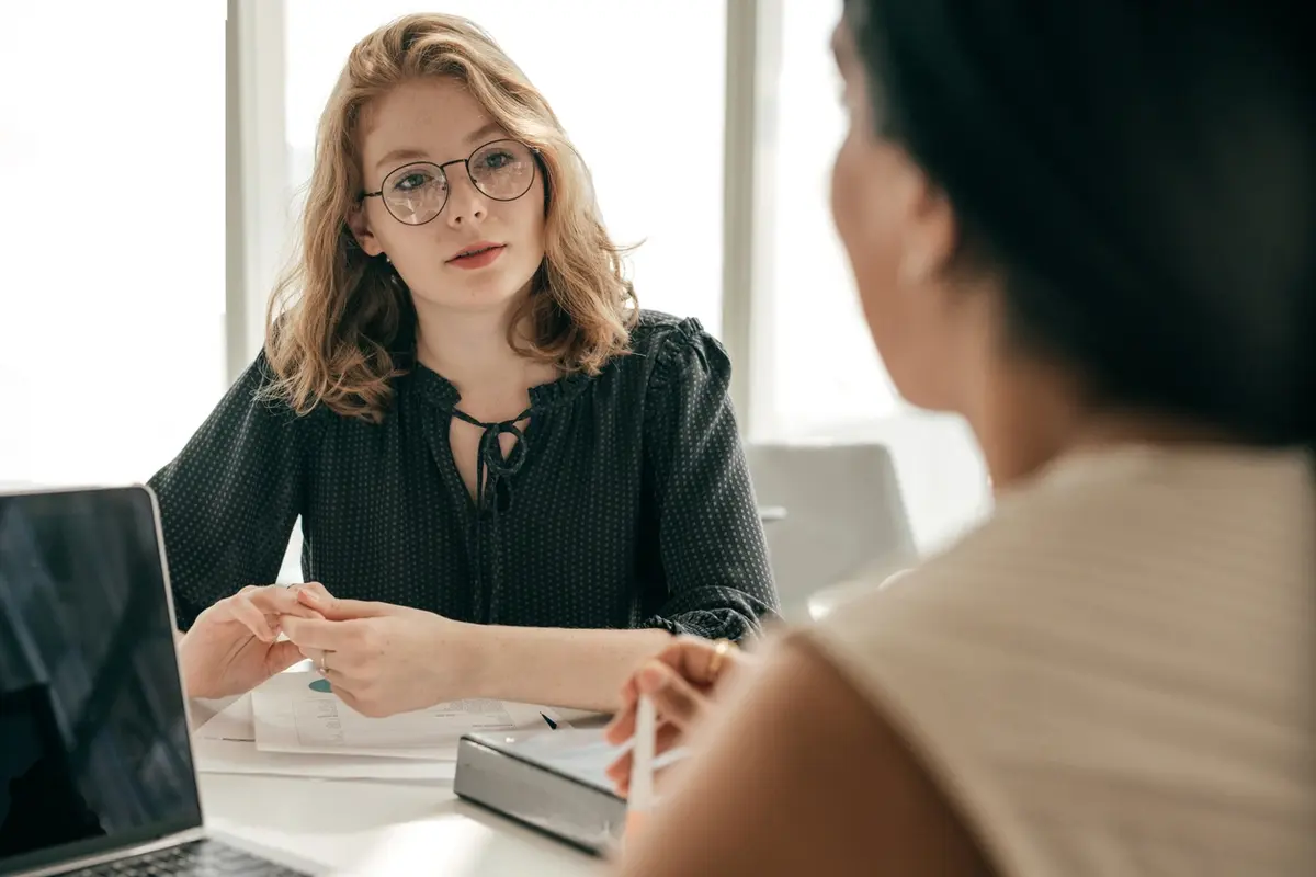Woman discusses executor options with a client during a private office consultation