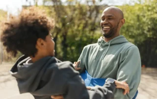 A parent and child share a playful outdoor moment, representing the family legacy and financial security a revocable living trust in California is designed to protect.