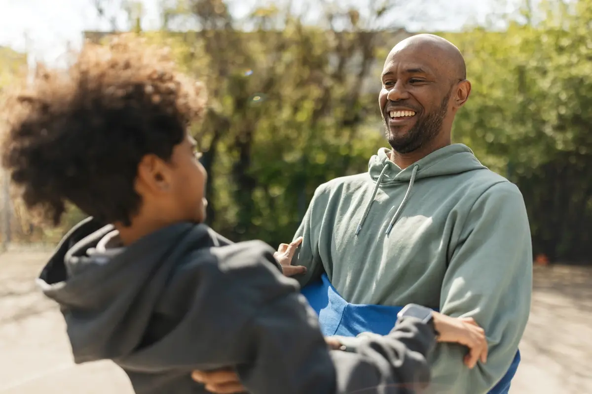 revocable living trust in california parent child outdoor moment A parent and child share a playful outdoor moment, representing the family legacy and financial security a revocable living trust in California is designed to protect.