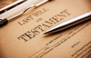 Blue ballpoint pen on a Last Will and Testament document representing end-of-life planning and estate preparation.
