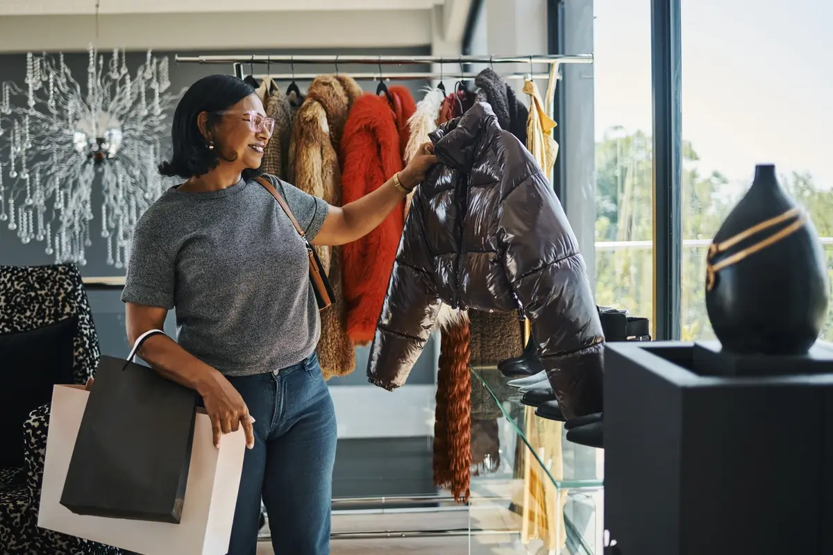 Hoarding and Estate Administration Support for Families Mature woman shopping for winter jackets, representing how hoarding can affect family decisions, possessions, and estate administration.
